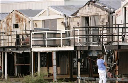A woman looks at homes damaged by Hurricane Katrina in a marina on Lake Pontchartrain in New Orleans, Louisiana, August 25, 2007. REUTERS/Lee Celano
A woman looks at homes damaged by Hurricane Katrina in a marina on Lake Pontchartrain in New Orleans, Louisiana, August 25, 2007. REUTERS/Lee Celano