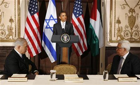
Israeli Prime Minister Benjamin Netanyahu (L) and Palestinian President Mahmoud Abbas (R) listen to President Barack Obama speak during a trilateral meeting with in New York in this September 22, 2009 file photo. REUTERS/Kevin Lamarque
