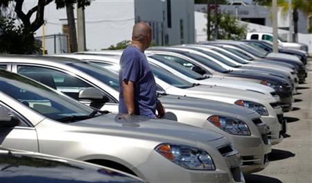 
A man walks next to Chevrolet vehicles at a GM dealership in Miami, Florida August 12, 2010. REUTERS/Carlos Barria
