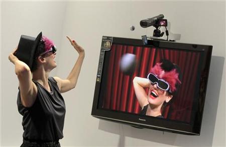 
A model demonstrates the Panasonic AVCHD 3D camcorder on press day of Internationale Funkausstellung (IFA) consumer electronics fair at "Messe Berlin" exhibition centre in Berlin, September 1, 2010. REUTERS/Thomas Peter
