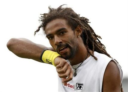 
Dustin Brown of Jamaica walks off the court after losing a game against Austria's Jurgen Meltzer at the 2010 Wimbledon Tennis Championships in London June 21, 2010. REUTERS/Phil Noble
