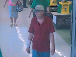 This surveillance photo shows the man suspected of using an offer to re-inflate a flat tire as a ruse to steal items from victims' purses left inside their cars (Photo courtesy Green Bay Police Dept.)
