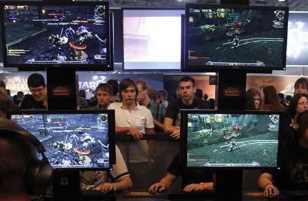 
Visitors play ''World of Warcraft'' at their exhibition stand at the Gamescom 2010 fair in Cologne August 19, 2010. REUTERS/Ina Fassbender
