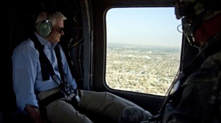 
Defense Secretary Robert Gates (C) looks out of the window of a Blackhawk helicopter as he departs Camp Ramadi onroute to Baghdad in Iraq September 1, 2010 a day after U.S. troops formally ended combat operations in the country. REUTERS/Jim Watson/Pool
