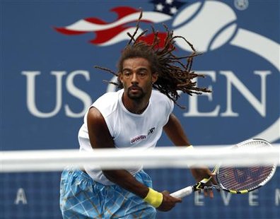 
Dustin Brown of Jamaica follows through on a serve to Andy Murray of Britain during the U.S. Open tennis tournament in New York, September 3, 2010. REUTERS/Kevin Lamarque
