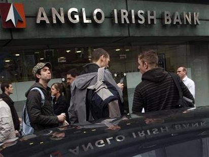 
Pedestrians walk past the Anglo Irish Bank head offices, in Belfast March 25, 2010. REUTERS/Cathal McNaughton
