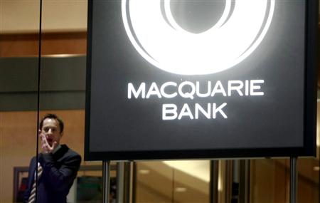 
A man stands next to a Macquarie Bank logo in Sydney in this August 1, 2007 file photo. REUTERS/Tim Wimborne/Files

