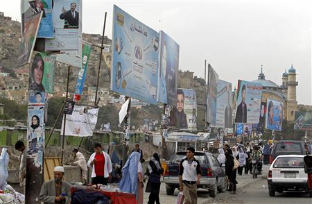
Afghan people walk under election campaign hoardings and posters at a market in Kabul September 6, 2010. Afghanistan will hold parliamentary elections on September 18. REUTERS/Fayaz Kabli
