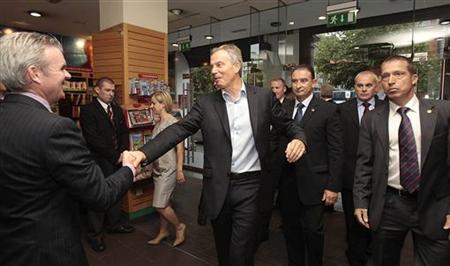 
Former British Prime Minister Tony Blair (4th L) is greeted by Conor Whelen (L), Managing Director of Eason book store in Dublin, Ireland September 4, 2010. REUTERS/Niall Carson/Pool
