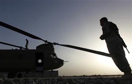 
U.S. Army personnel work on a Chinook transport chopper in Kandahar's NATO airfield May 2, 2010. REUTERS/Yannis Behrakis
