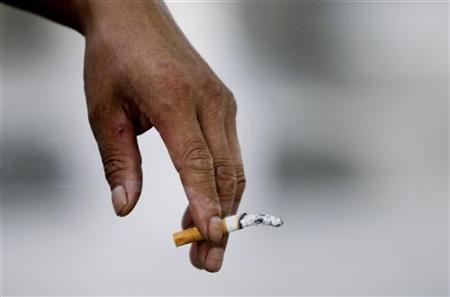 
A man smokes a cigarette in Beijing August 18, 2010. REUTERS/Jason Lee
