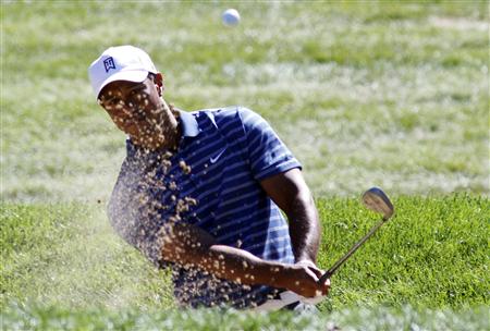 
Tiger Woods hits out of a bunker during a pro-am at the the BMW Championship golf tournament in Lemont, Illinois September 8, 2010. REUTERS/Frank Polich

