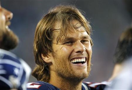 
New England Patriots quarterback Tom Brady laughs with his teammates on the sideline during the fourth quarter of their NFL preseason football game against the St. Louis Rams in Foxborough, Massachusetts August 26, 2010. REUTERS/Brian Snyder
