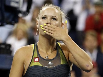 
Caroline Wozniacki of Denmark blows a kiss to the crowd after defeating Dominika Cibulkova of Slovakia during the U.S. Open tennis tournament in New York September 8, 2010. REUTERS/Mike Segar

