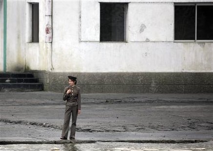 
A female North Korean soldier stands guard on the banks of the Yalu River near the North Korean town of Sinuiju, opposite the Chinese border city of Dandong, September 9, 2010. REUTERS/Jacky Chen
