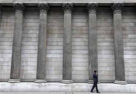 
A man speaks on a mobile phone next to columns outside the Bank of England, in the City of London, August 17, 2010. REUTERS/Andrew Winning
