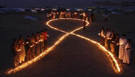 
Activists from a non-governmental organisation (NGO) attend an AIDS awareness campaign on the eve of the World AIDS Day at Nalsarovar Bird Sanctuary Lake, about 60 km (37 miles) west of the western Indian city of Ahmedabad November 30, 2009. REUTERS/Amit Dave
