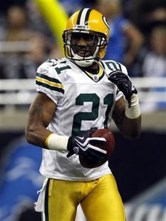 Green Bay Packers' Charles Woodson celebrates after he returned an interception for a score against the Detroit Lions during the second half of their Thanksgiving Day NFL football game in Detroit, Michigan November 26, 2009. REUTERS/Rebecca Cook
Green Bay Packers' Charles Woodson celebrates after he returned an interception for a score against the Detroit Lions during the second half of their Thanksgiving Day NFL football game in Detroit, Michigan November 26, 2009. REUTERS/Rebecca Cook