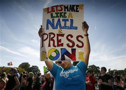 
A participant holds up a sign during a gay rights demonstration in Washington October 11, 2009. REUTERS/Molly Riley
