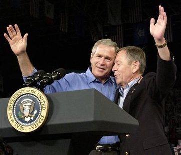 
U.S. President George W. Bush and Senator George Voinovich (R-OH) wave from the stage before the president delivered remarks at the Canton Memorial Civic Center in Canton, Ohio July 31, 2004. REUTERS/Mannie Garcia
