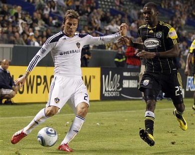 Los Angeles Galaxy midfielder David Beckham (R) makes a shot on goal past Columbus Crew's Shaun Francis during the second half of their MLS soccer match in Carson, California, September 11, 2010. REUTERS/Lucy Nicholson
Los Angeles Galaxy midfielder David Beckham (R) makes a shot on goal past Columbus Crew's Shaun Francis during the second half of their MLS soccer match in Carson, California, September 11, 2010. REUTERS/Lucy Nicholson