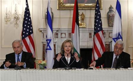 
Secretary of State Hillary Clinton (C) speaks about the Middle East peace talks with Israel's Prime Minister Benjamin Netanyahu (L) and Palestinian President Mahmoud Abbas at the State Department in Washington September 2, 2010. REUTERS/Jim Young
