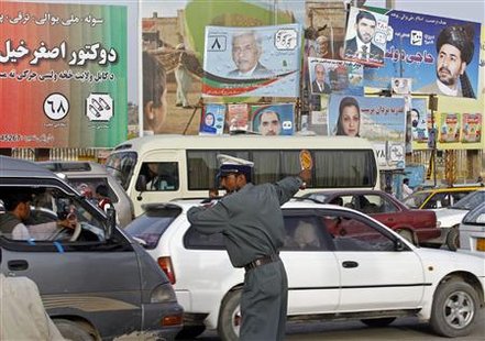 An Afghan traffic policeman directs traffic on a busy road adorned with pictures of candidates taking part in the forthcoming parliamentary elections in Kabul September 15, 2010. REUTERS/Fayaz Kabli
An Afghan traffic policeman directs traffic on a busy road adorned with pictures of candidates taking part in the forthcoming parliamentary elections in Kabul September 15, 2010. REUTERS/Fayaz Kabli