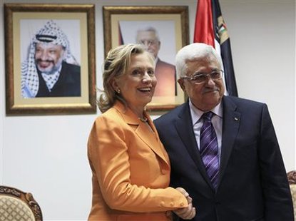 
Palestinian President Mahmoud Abbas (R) and U.S. Secretary of State Hillary Clinton shake hands during their meeting in the West Bank city of Ramallah September 16, 2010. REUTERS/Fadi Arouri/Pool
