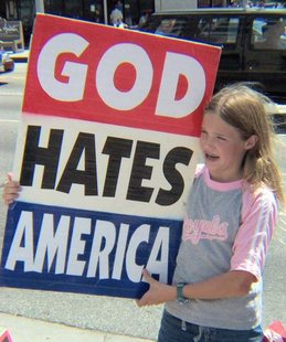 A Protester Holds A Sign Outside A Church (Picture is File Photo from www.getreligion.org) A Protester Holds A Sign Outside A Church (Picture is File Photo from www.getreligion.org)