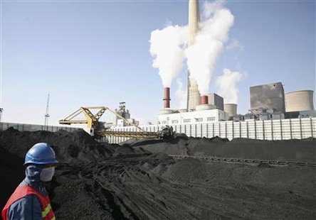 
A worker stands at a coal dump site of Daba power plant in Qingtongxia, Ningxia Hui Autonomous Region October 8, 2010. REUTERS/Tom Yz
