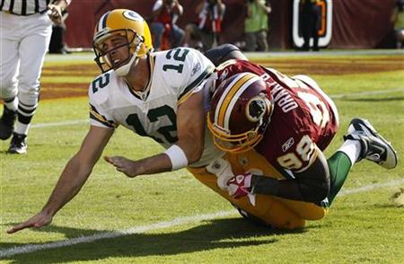 Green Bay Packers quarterback Aaron Rodgers is hit by Washington Redskins Brian Orakpo after throwing the ball in the second half of their NFL game in Landover, Maryland, October 10, 2010. REUTERS/Larry Downing
Green Bay Packers quarterback Aaron Rodgers is hit by Washington Redskins Brian Orakpo after throwing the ball in the second half of their NFL game in Landover, Maryland, October 10, 2010. REUTERS/Larry Downing