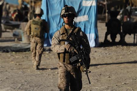 
U.S. Marines patrol through the market in the town of Musa Qala in southern Afghanistan's Helmand province, October 18, 2010. REUTERS/Finbarr O'Reilly
