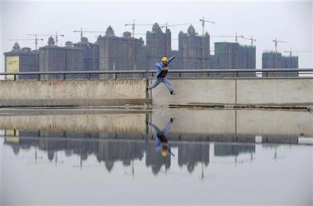 A worker jumps over a puddle near a residential construction site in Taiyuan, Shanxi province October 26, 2010. REUTERS/Stringer
A worker jumps over a puddle near a residential construction site in Taiyuan, Shanxi province October 26, 2010. REUTERS/Stringer