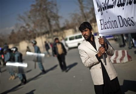 A supporter of Afghan candidates for the parliamentary elections holds a banner during a protest in Kabul November 24, 2010. Afghan election candidates took to the streets of Kabul on Wednesday to protest against a polling process they say was corrupt and shameful ahead of the expected announcement of final results from the Sept. 18 vote. REUTERS/Ahmad Masood
A supporter of Afghan candidates for the parliamentary elections holds a banner during a protest in Kabul November 24, 2010. Afghan election candidates took to the streets of Kabul on Wednesday to protest against a polling process they say was corrupt and shameful ahead of the expected announcement of final results from the Sept. 18 vote. REUTERS/Ahmad Masood