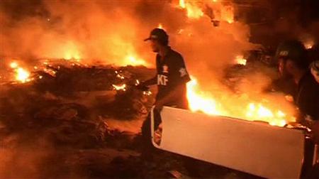 A frame grab shows rescue workers carrying a stretcher at the scene of a plane crash in Karachi November 28, 2010. REUTERS/via Reuters TV
A frame grab shows rescue workers carrying a stretcher at the scene of a plane crash in Karachi November 28, 2010. REUTERS/via Reuters TV
