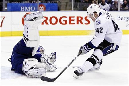 
Tampa Bay Lightning Dana Tyrell is stopped on a shot by Toronto Maple Leafs goalie Jonas Gustavsson during the frist period of their NHL game in Toronto, November 30, 2010. REUTERS/Mark Blinch
