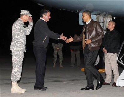 President Obama is greeted by U.S. Ambassador to Afghanistan Karl Eikenberry and Commander of U.S. forces in Afghanistan General David Petraeus as he arrives at Bagram Air Base, Afghanistan, December 3, 2010. REUTERS/Jim Young
President Obama is greeted by U.S. Ambassador to Afghanistan Karl Eikenberry and Commander of U.S. forces in Afghanistan General David Petraeus as he arrives at Bagram Air Base, Afghanistan, December 3, 2010. REUTERS/Jim Young