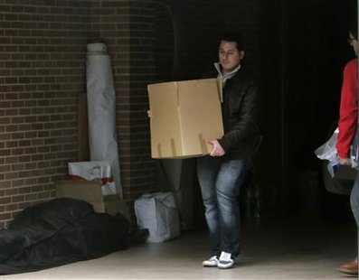 
A policeman carries a box following a search at Spanish athlete Marta Dominguez's house in Palencia, December 10, 2010. REUTERS/Stringer
