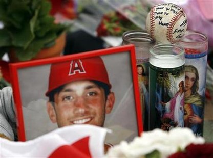 A baseball with a note on it is seen among other items at a memorial for Los Angeles Angels pitcher Nick Adenhart at Angel Stadium, before the game between the Los Angeles Angels and the Boston Red Sox in Anaheim, California, in this April 10, 2009 file photo. REUTERS/Danny Moloshok/Files
A baseball with a note on it is seen among other items at a memorial for Los Angeles Angels pitcher Nick Adenhart at Angel Stadium, before the game between the Los Angeles Angels and the Boston Red Sox in Anaheim, California, in this April 10, 2009 file photo. REUTERS/Danny Moloshok/Files