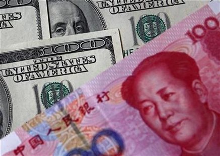A 100 yuan banknote (bottom) is placed next to U.S. $100 banknotes in this picture illustration taken in Beijing in this November 1, 2010 file photo. REUTERS/Petar Kujundzic
A 100 yuan banknote (bottom) is placed next to U.S. $100 banknotes in this picture illustration taken in Beijing in this November 1, 2010 file photo. REUTERS/Petar Kujundzic