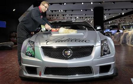 Michael Price cleans a Cadillac CTS-V coupe race car before its debut for press days at the North American International Auto show in Detroit, Michigan January 8, 2011. REUTERS/Rebecca Cook
Michael Price cleans a Cadillac CTS-V coupe race car before its debut for press days at the North American International Auto show in Detroit, Michigan January 8, 2011. REUTERS/Rebecca Cook