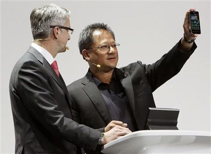 Audi AG Chairman Rupert Stadler (L) watches as Nvidia CEO Jen-Hsun Huang shows off a latest generation smartphone using a Tegra 2 chip during the Audi keynote address on the opening day of the Consumer Electronics Show (CES) in Las Vegas January 6, 2011. REUTERS/Rick Wilking
Audi AG Chairman Rupert Stadler (L) watches as Nvidia CEO Jen-Hsun Huang shows off a latest generation smartphone using a Tegra 2 chip during the Audi keynote address on the opening day of the Consumer Electronics Show (CES) in Las Vegas January 6, 2011. REUTERS/Rick Wilking
