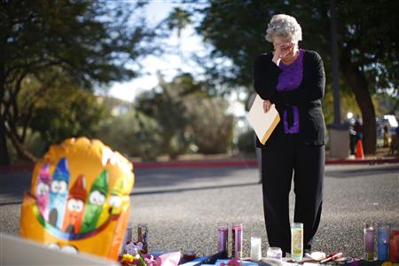 A woman cries at a makeshift memorial set up for the victims of the January 8 shooting, outside the University Medical Center in Tucson, Arizona January 12, 2011. REUTERS/Eric Thayer
A woman cries at a makeshift memorial set up for the victims of the January 8 shooting, outside the University Medical Center in Tucson, Arizona January 12, 2011. REUTERS/Eric Thayer