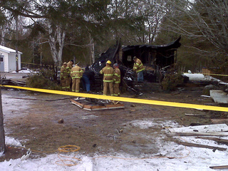 Firefighters investigate the scene of a fire in the Marinette County Town of Lake, Jan. 12, 2011. (courtesy of FOX 11). Firefighters investigate the scene of a fire in the Marinette County Town of Lake, Jan. 12, 2011. (courtesy of FOX 11).