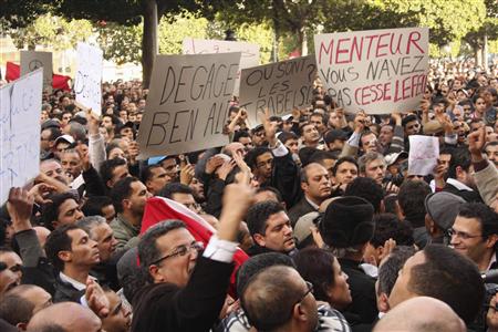 
Tunisians shout slogans as they demonstrate against Tunisian President Zine al-Abidine Ben Ali in Tunis January 14, 2011. The banners read "Get out, Ben Ali" (L) and "Liar, you haven't stopped shooting" (R). REUTERS/Zoubeir Souissi
