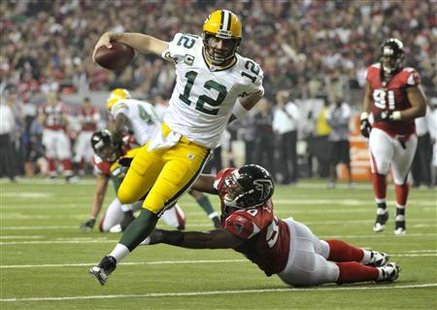 Green Bay Packers quarterback Aaron Rodgers (12) runs into the end zone past Atlanta Falcons linebacker Curtis Lofton for a touchdown in the 3rd quarter during their NFC Divisional NFL playoff football game in Atlanta January 15, 2011. REUTERS/Rich Addicks
Green Bay Packers quarterback Aaron Rodgers (12) runs into the end zone past Atlanta Falcons linebacker Curtis Lofton for a touchdown in the 3rd quarter during their NFC Divisional NFL playoff football game in Atlanta January 15, 2011. REUTERS/Rich Addicks