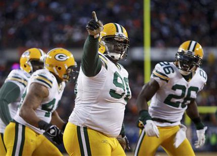 Green Bay Packers defensive tackle B.J. Raji (90) celebrates his touchdown after intercepting a Chicago Bears pass during the fourth quarter of the NFL NFC Championship football game in Chicago, January 23, 2011. REUTERS/John Gress
Green Bay Packers defensive tackle B.J. Raji (90) celebrates his touchdown after intercepting a Chicago Bears pass during the fourth quarter of the NFL NFC Championship football game in Chicago, January 23, 2011. REUTERS/John Gress