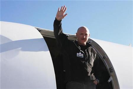 NASA Shuttle Commander Mark Kelly, the husband of U.S. Representative Gabrielle Giffords (D-AZ), waves from a medical transport plane bound for Houston, after his wife was carried aboard in Tucson, Arizona, in this photograph taken and released on January 21, 2011. REUTERS/Office of Rep. Gabrielle Giffords/Jennifer Polixenni Brankin/Handout
NASA Shuttle Commander Mark Kelly, the husband of U.S. Representative Gabrielle Giffords (D-AZ), waves from a medical transport plane bound for Houston, after his wife was carried aboard in Tucson, Arizona, in this photograph taken and released on January 21, 2011. REUTERS/Office of Rep. Gabrielle Giffords/Jennifer Polixenni Brankin/Handout
