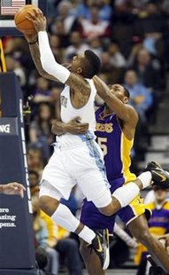 Los Angeles Lakers forward Ron Artest (back) fouls Denver Nuggets guard J.R. Smith in their NBA basketball game in Denver January 21, 2011. REUTERS/Rick Wilking
Los Angeles Lakers forward Ron Artest (back) fouls Denver Nuggets guard J.R. Smith in their NBA basketball game in Denver January 21, 2011. REUTERS/Rick Wilking
