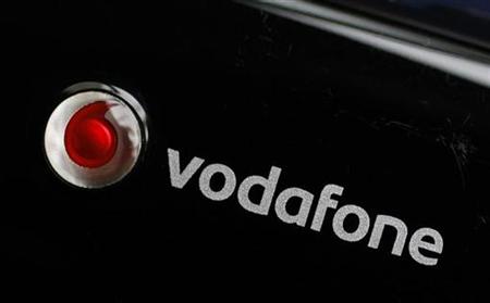 
A Vodafone logo is seen on a mobile internet dongle connected to a laptop in London November 9, 2010. REUTERS/Suzanne Plunkett
